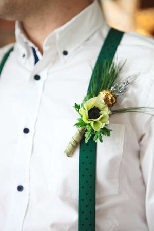 Groom wearing buttonhole with white anemone and fur treeの写真素材