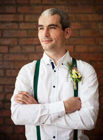 Groom wearing buttonhole with white anemone and fur treeの写真素材