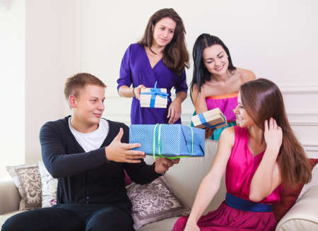 Portrait of joyful girl at birthday party surrounded by friends at partyの写真素材