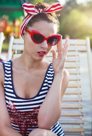 Beautiful pin up girl near the swimming pool. Summertimeの写真素材