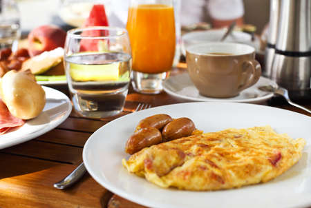 Tasty breakfast in the morning with omelet and sausagesの写真素材