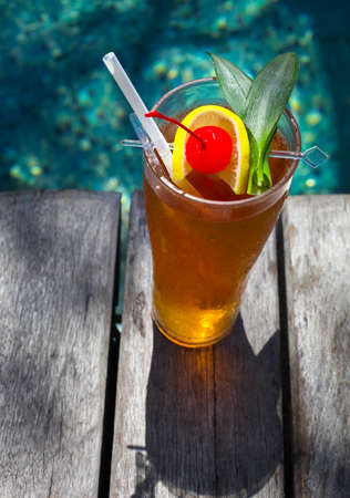 Cocktail near the swimming pool on the background of the water