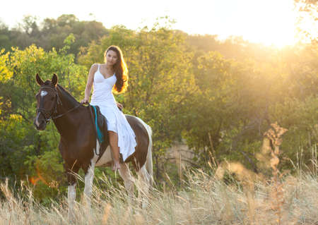 Beautiful woman and a horse. Summer timeの写真素材