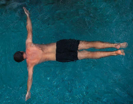 Athletic young man swimming in the poolの写真素材