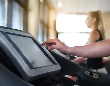 Healthy couple running on a treadmill in a sport centreの写真素材