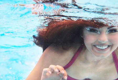 Underwater woman close up portrait in swimming poolの写真素材