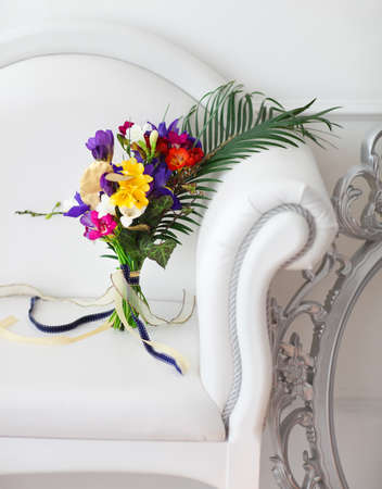 Beautiful colorful wedding bouquet on the white sofaの写真素材