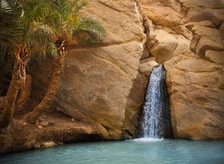 View of mountain oasis Chebika with waterfall, Sahara desert, Tunisia, Africaの写真素材