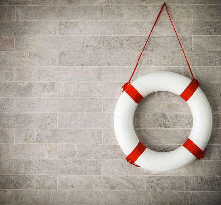 White and red lifebuoy at background, copyspace for your textの写真素材