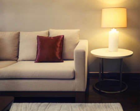 Cozy beautiful living room with baige sofa and lamp with copy space. Toned image.の写真素材