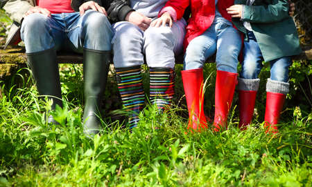 Happy family wearing colorful rain boots. Family conceptの写真素材