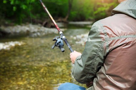 Fisherman with fly-fishing on mountain river. Spring timeの写真素材
