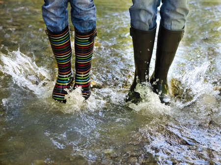 Happy couple wearing colorful rain boots. Happiness and fun conceptの写真素材