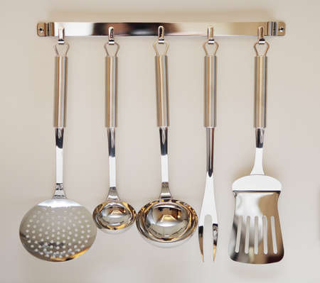 Set of black modern kitchen utensil hanging on beige background