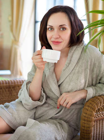 Young relaxed woman drinking tea at spa resortの写真素材