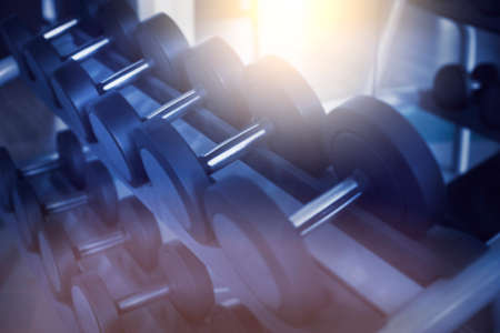 Dumbbells in modern sports club. Weight training equipment. Toned imageの写真素材