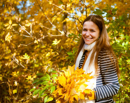 Portrait of a beautiful teenage girl having fun in autumn park .Outdoor