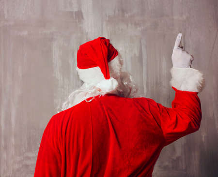 Santa Claus pointing or showing and rear view.の写真素材