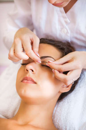Beautiful young woman in cosmetic salon. Close up