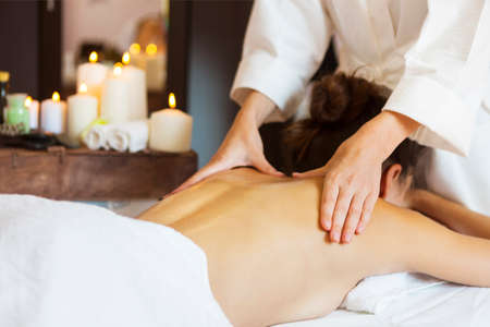 Beautiful young woman relaxing with hand massage at beauty spa. Close upの写真素材