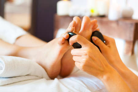 Massage of female foot in spa salon. Healthy lifestyle and relaxation concept. Close upの写真素材