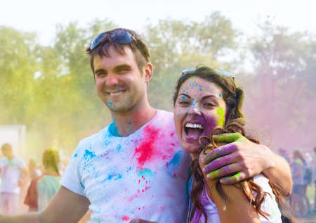 Portrait of happy couple in love on holi color festival
