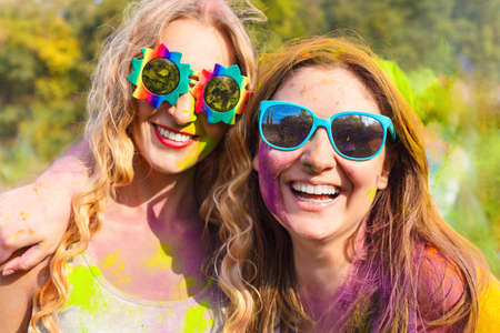 Portrait of happy young girls on holi color festival