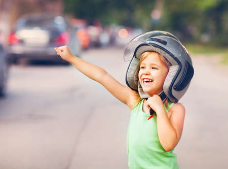 Happy kid playing in helmet outdoors. Travel and fun conceptの写真素材