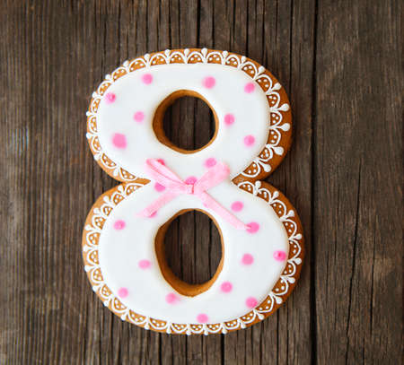 Cookies number eight. Gingerbread cookie on the rustic wooden backgroundの写真素材