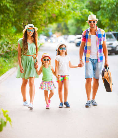 Happy young family walking with guitar spending carefree time together. Travel and holiday conceptの写真素材
