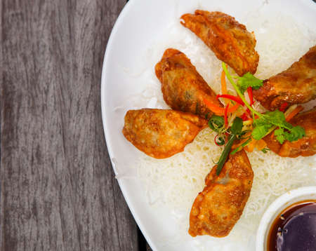 Fried Chinese Traditional Gyoza or Dumpling on the wooden tableの写真素材