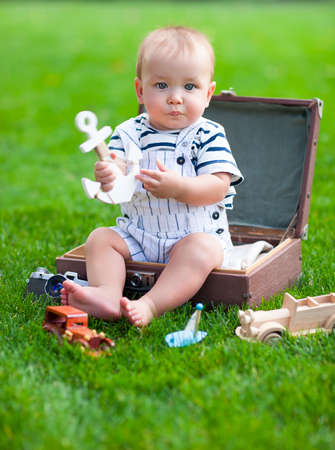 Close up portrait of the smiling baby boy playing outdoors. Holliday and travel conceptの写真素材