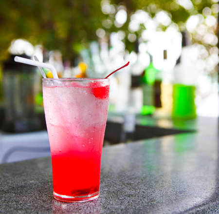 Strawberry red cocktail garnished with cherry. Close upの写真素材