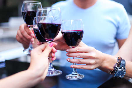 Close up of hands of a friends toasting in restaurant