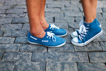 Happy couple. Boyfriend and girlfriend feet wearing sneakersの写真素材