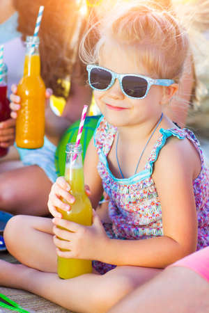 Little smiling girl with lemonadeの写真素材