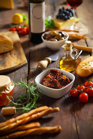 Italian food ingredients with red wine on wooden backgroundの写真素材