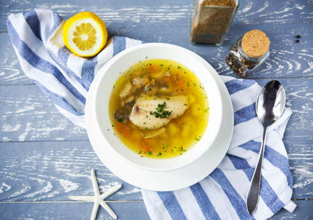 Fish soup with potato on the wooden tableの写真素材