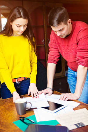 Business team at work with financial reports and a tablet computer