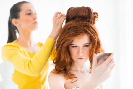 Hair stylist makes the bride before the weddingの写真素材