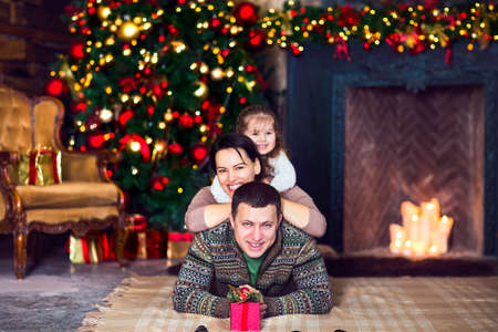 Christmas family portrait In home holiday living room with decorated Christmas treeの写真素材