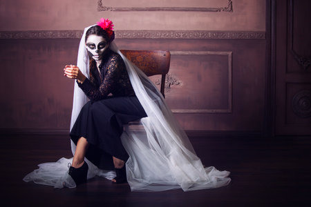 Young beautiful woman painted face as skeleton. Halloween or calavera themeの写真素材