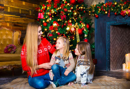 Hugging mother and daughters. Christmas happiness conceptの写真素材