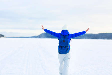 Young woman hiking in white winter forest. Lifestyle conceptの写真素材