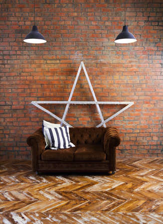 Interior of loft with velvet sofa and lamps. Copy spaceの写真素材