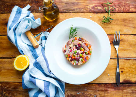 Traditional Russian salad Herring under a fur coat on the wooden tableの写真素材