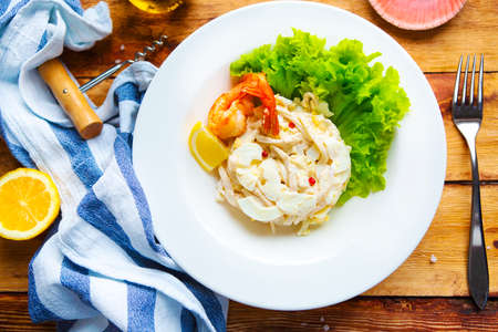 Seafood salad on wooden tableの写真素材