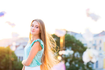 Outdoors portrait of beautiful young blond woman looking at camera.の写真素材