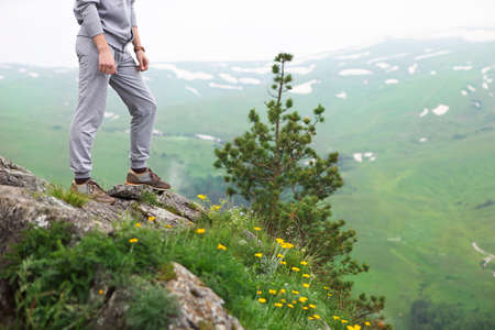 Hipster man on the top of mountain. Close upの写真素材