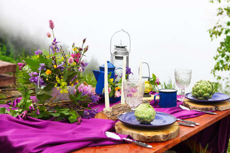 Wedding table setting decorated in rustic style. Mountains view